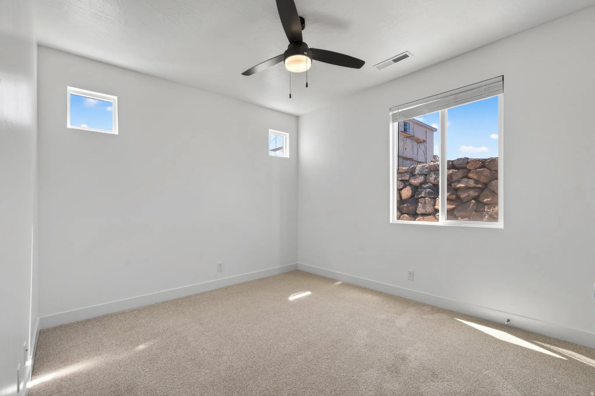 Neutral-toned carpet flooring complementing bright white walls