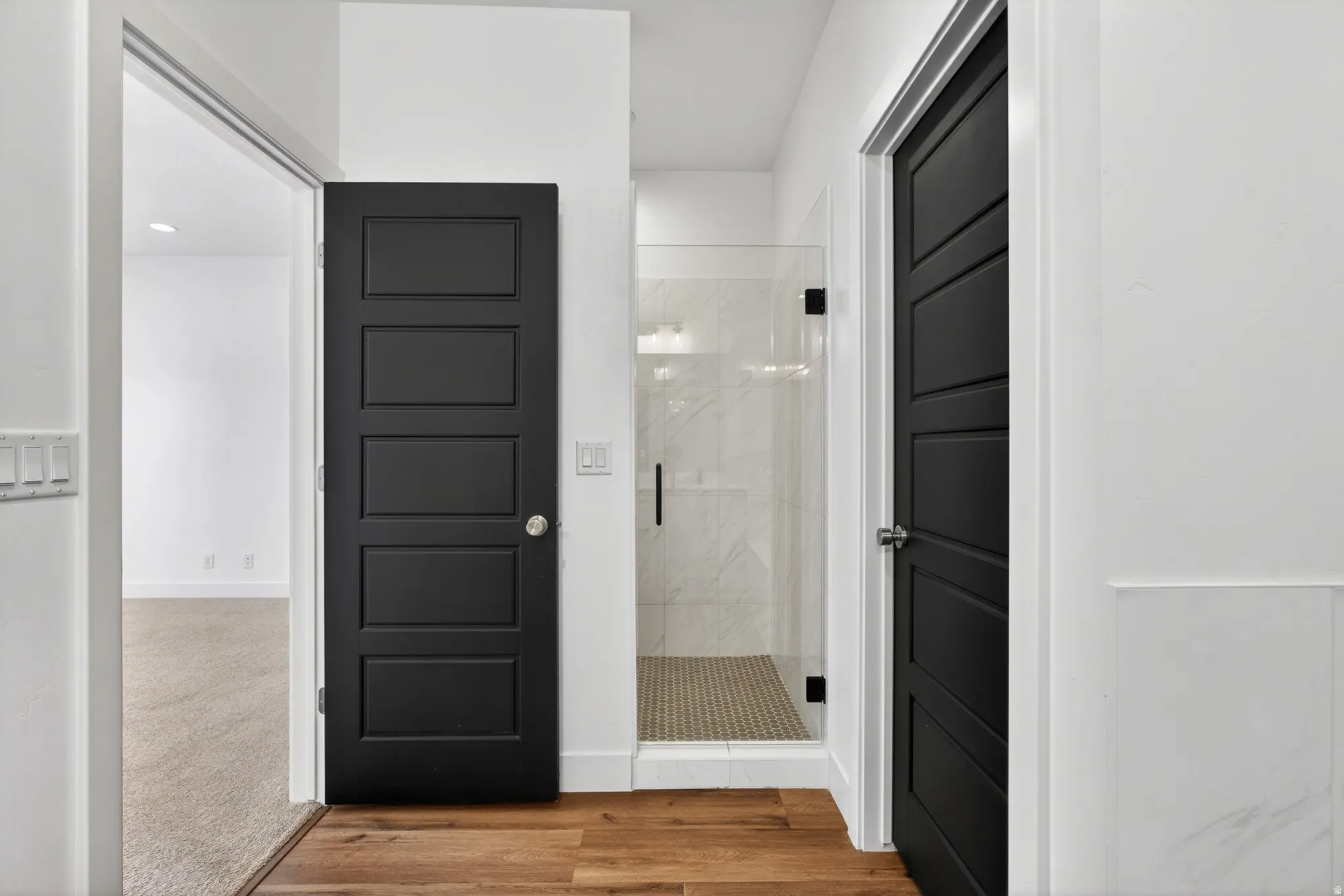 Modern full-lite shower with clear glass enclosure and black hardware