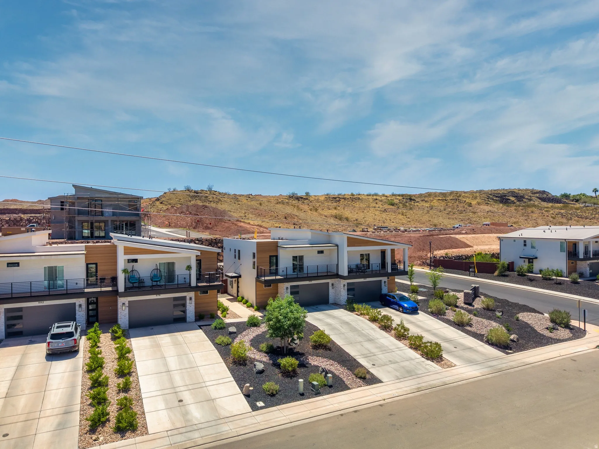 Modern architectural design featuring white stucco and wood-finish siding