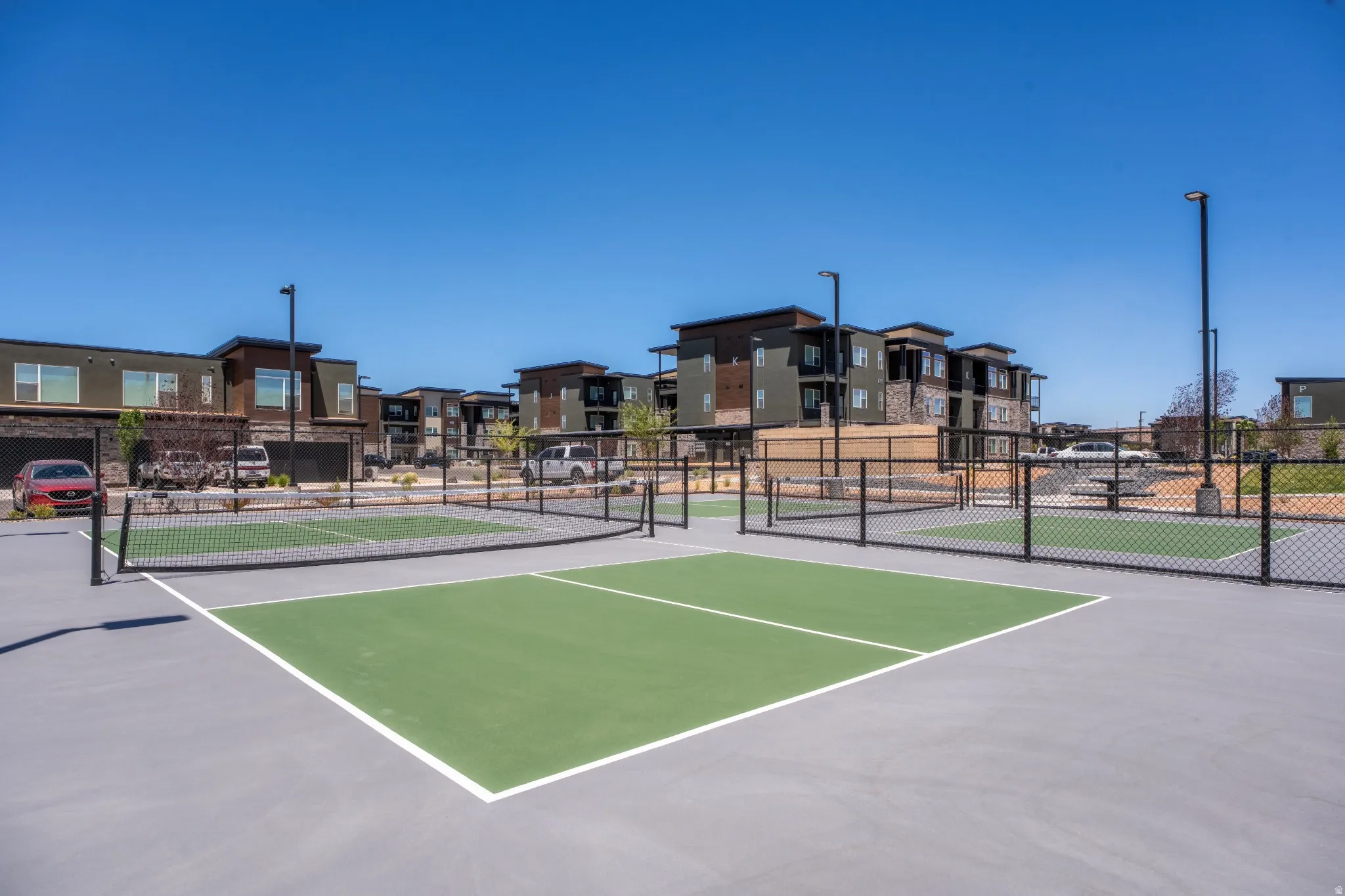 Outdoor pickleball courts featuring a green playing surface and white line markings