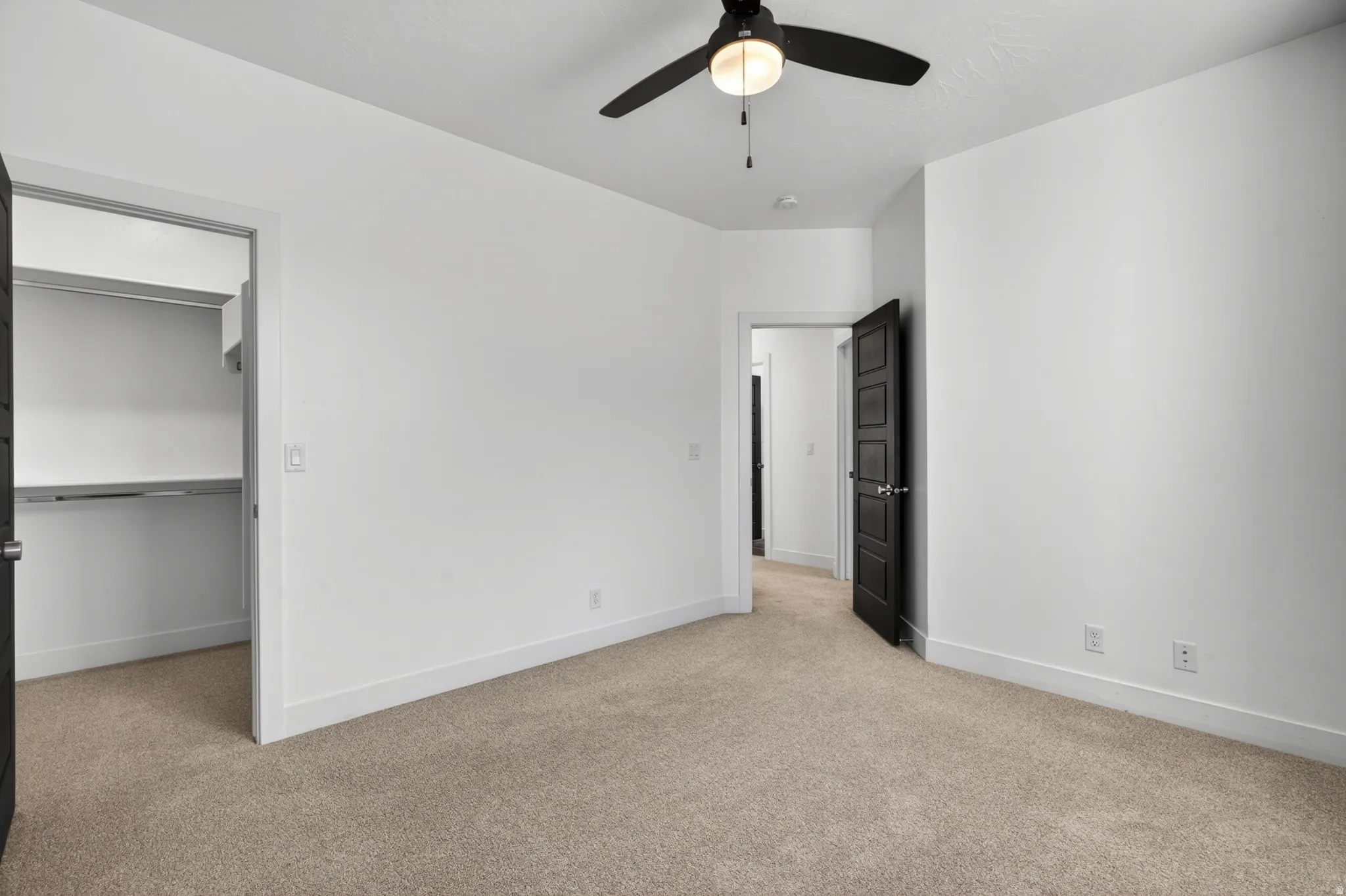 Neutral-toned carpeting paired with bright white walls and trim