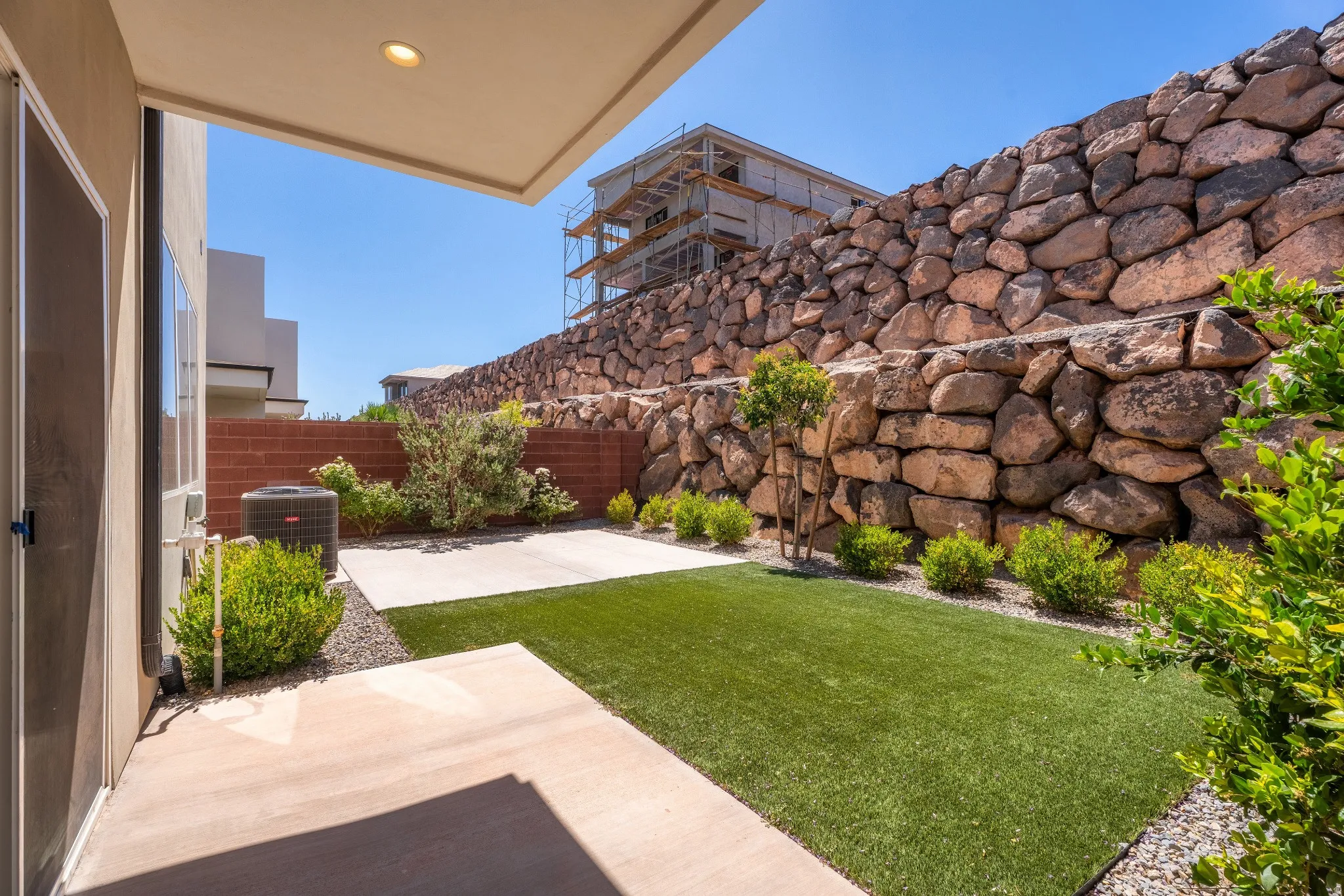 Patio area with concrete pavers and artificial turf