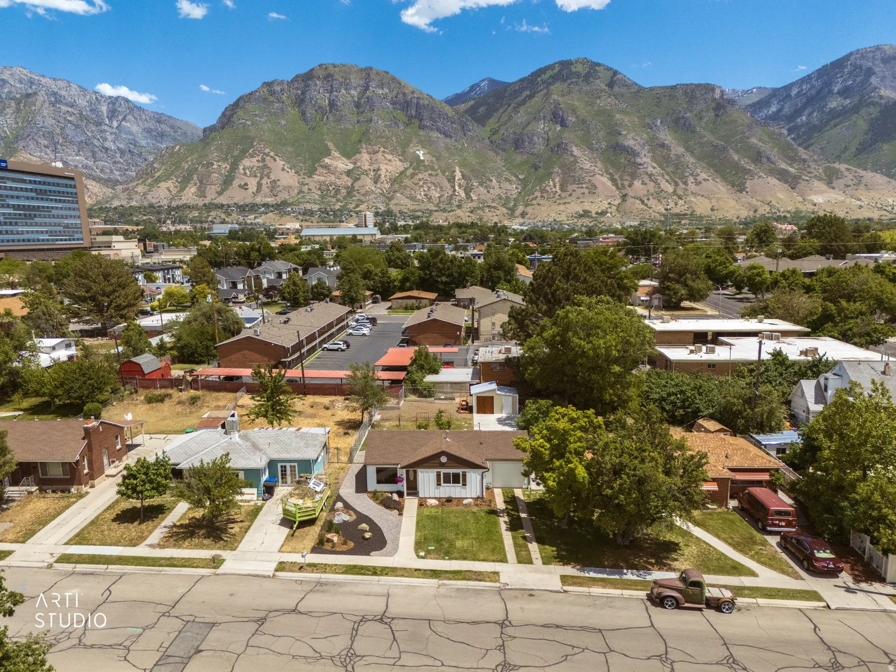 Aerial perspective showcasing a residential neighborhood with prominent mountain backdrop