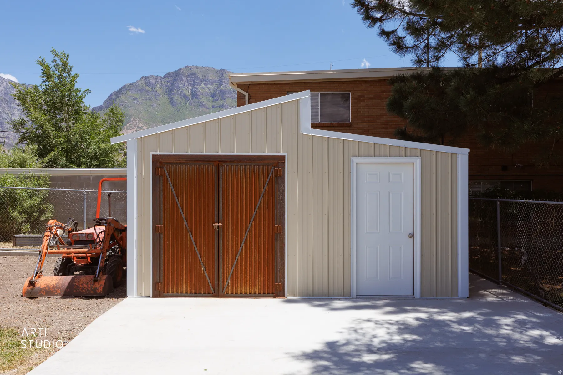 Newly constructed outbuilding featuring a sloped roofline, beige vertical siding, and white trim