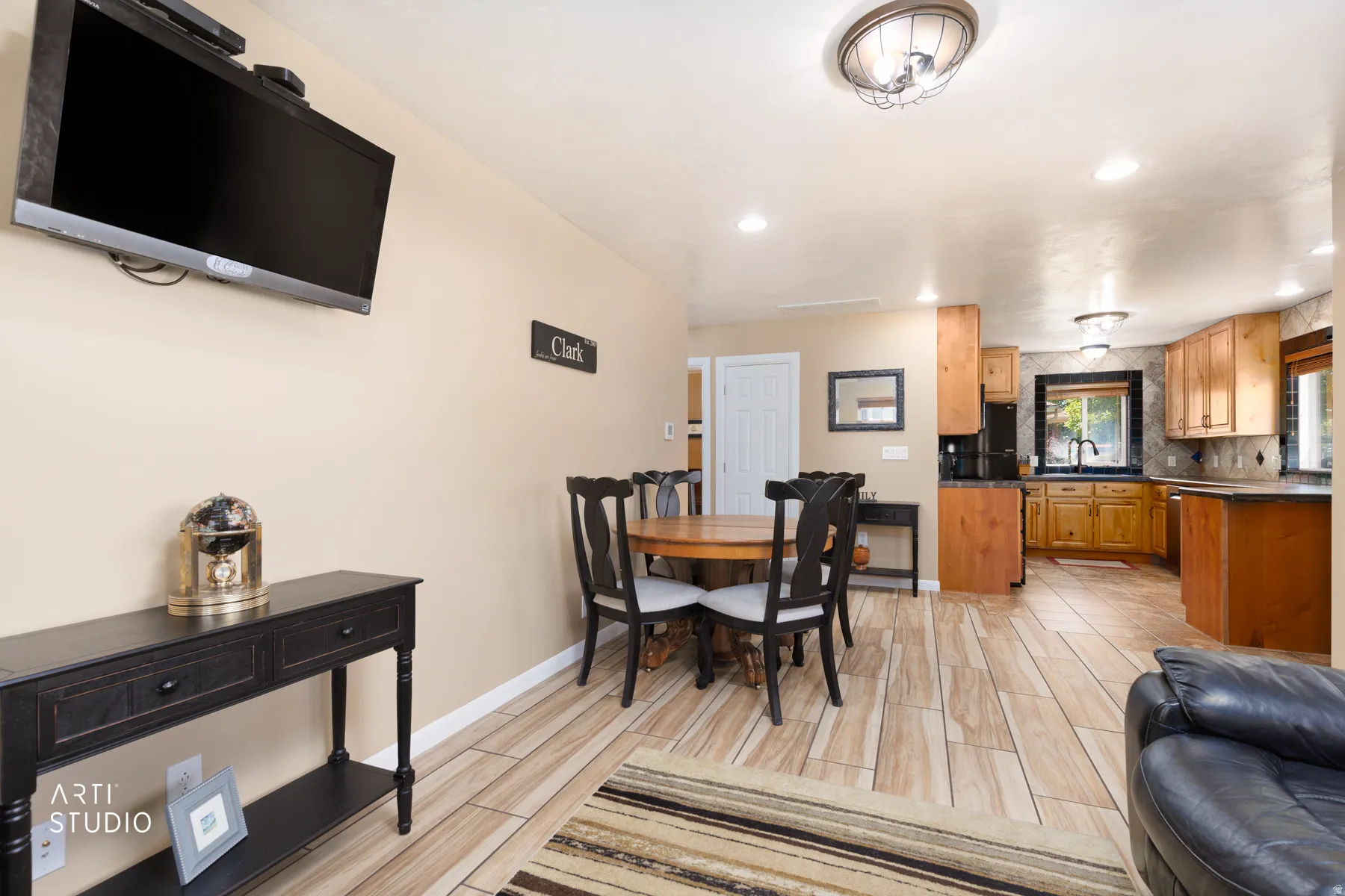 Open-concept living area with wood-finish flooring extending into the kitchen