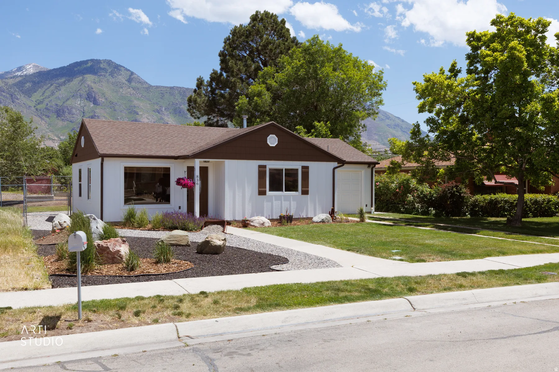 Ranch-style exterior with white siding and brown trim