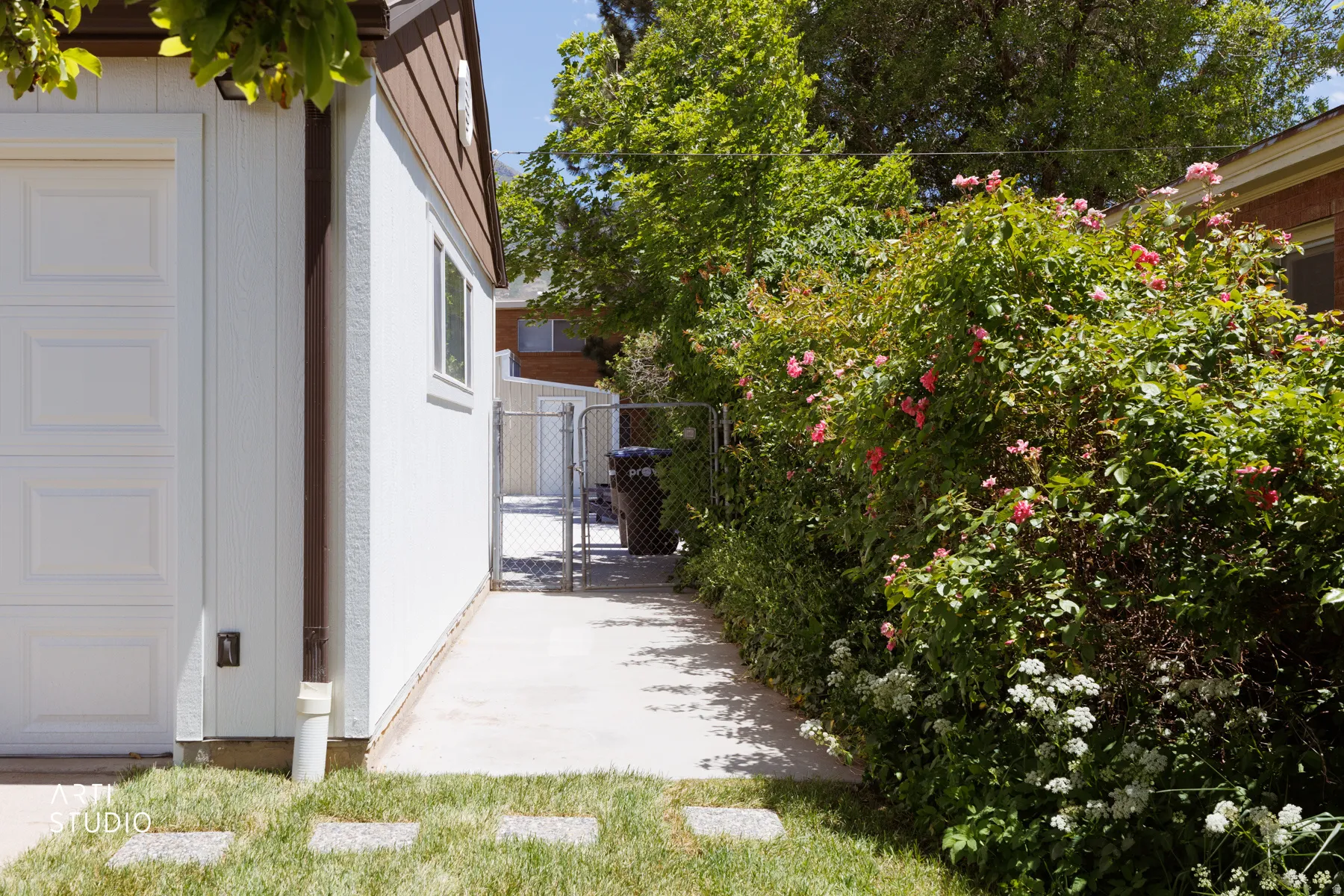 White siding garage with a brown fascia and soffit