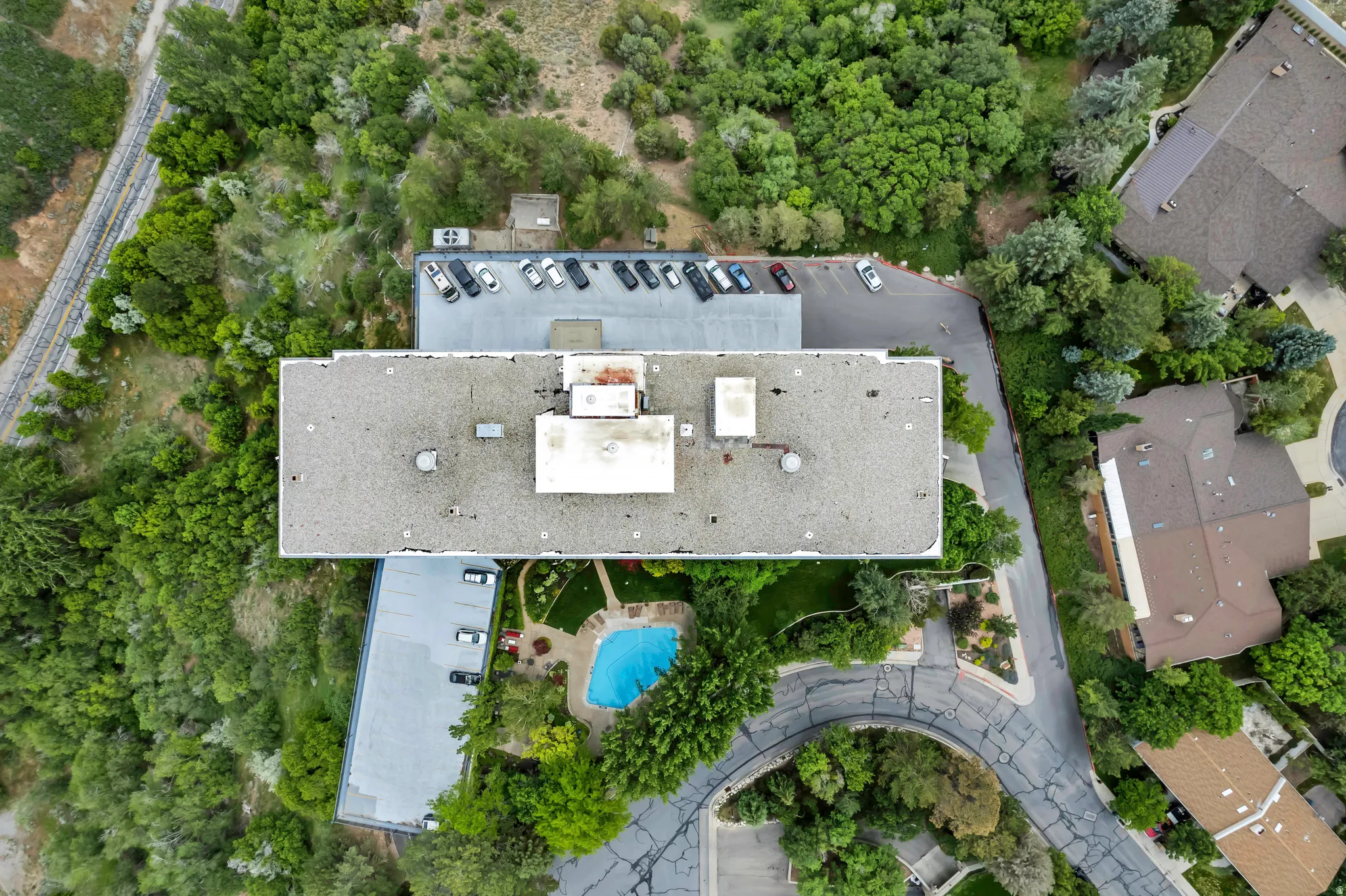 Aerial perspective showcasing the parking and common area pool and gardens