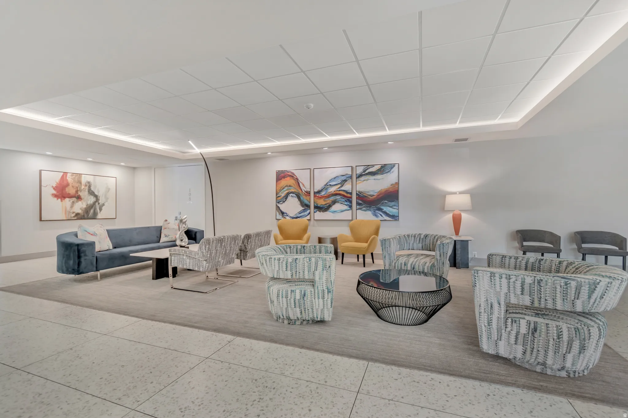 Spacious common area featuring recessed lighting, a coffered ceiling, and large format tile flooring