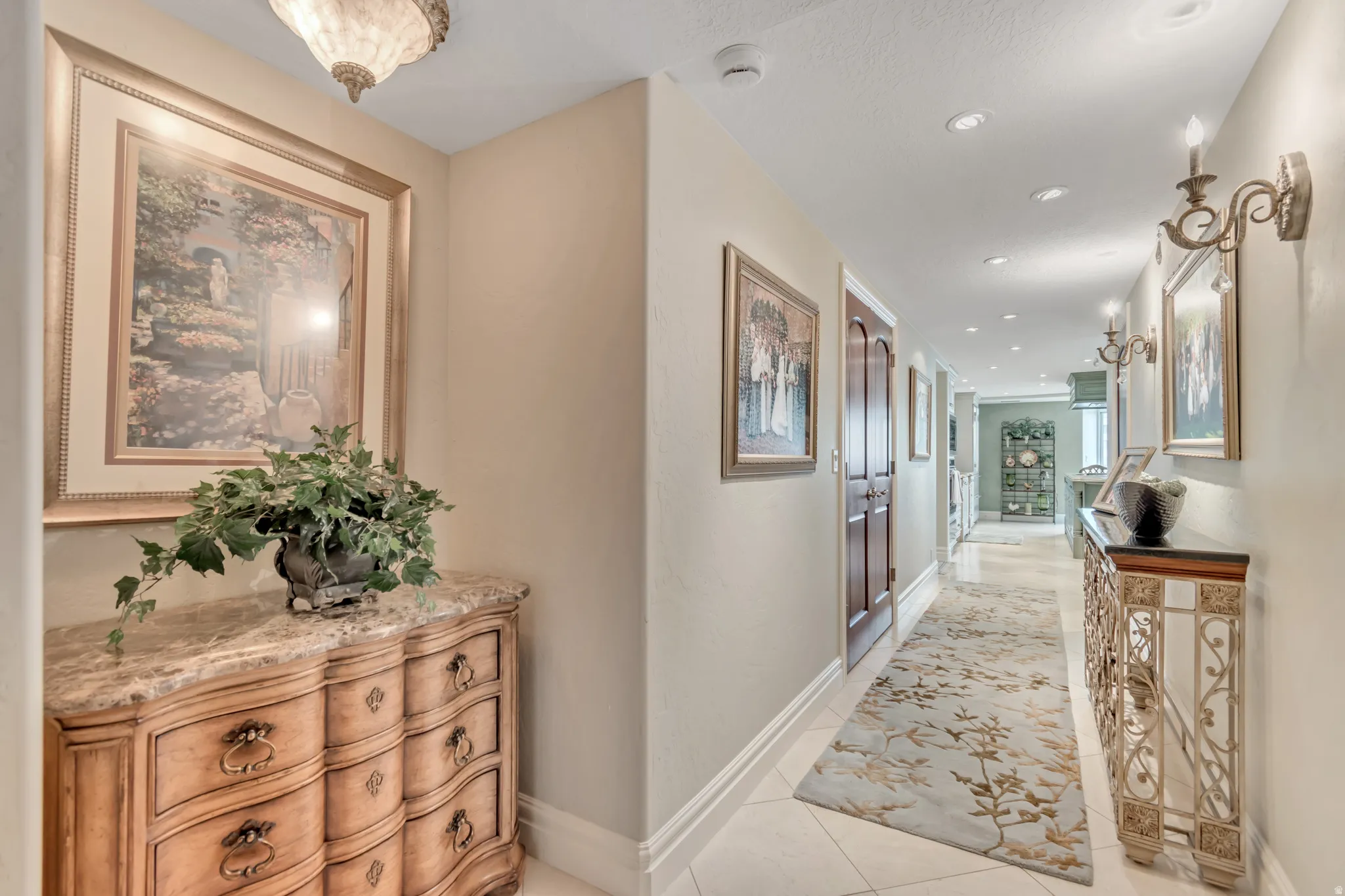 Hallway featuring recessed lighting, decorative wall sconces, and light-toned wall paint
