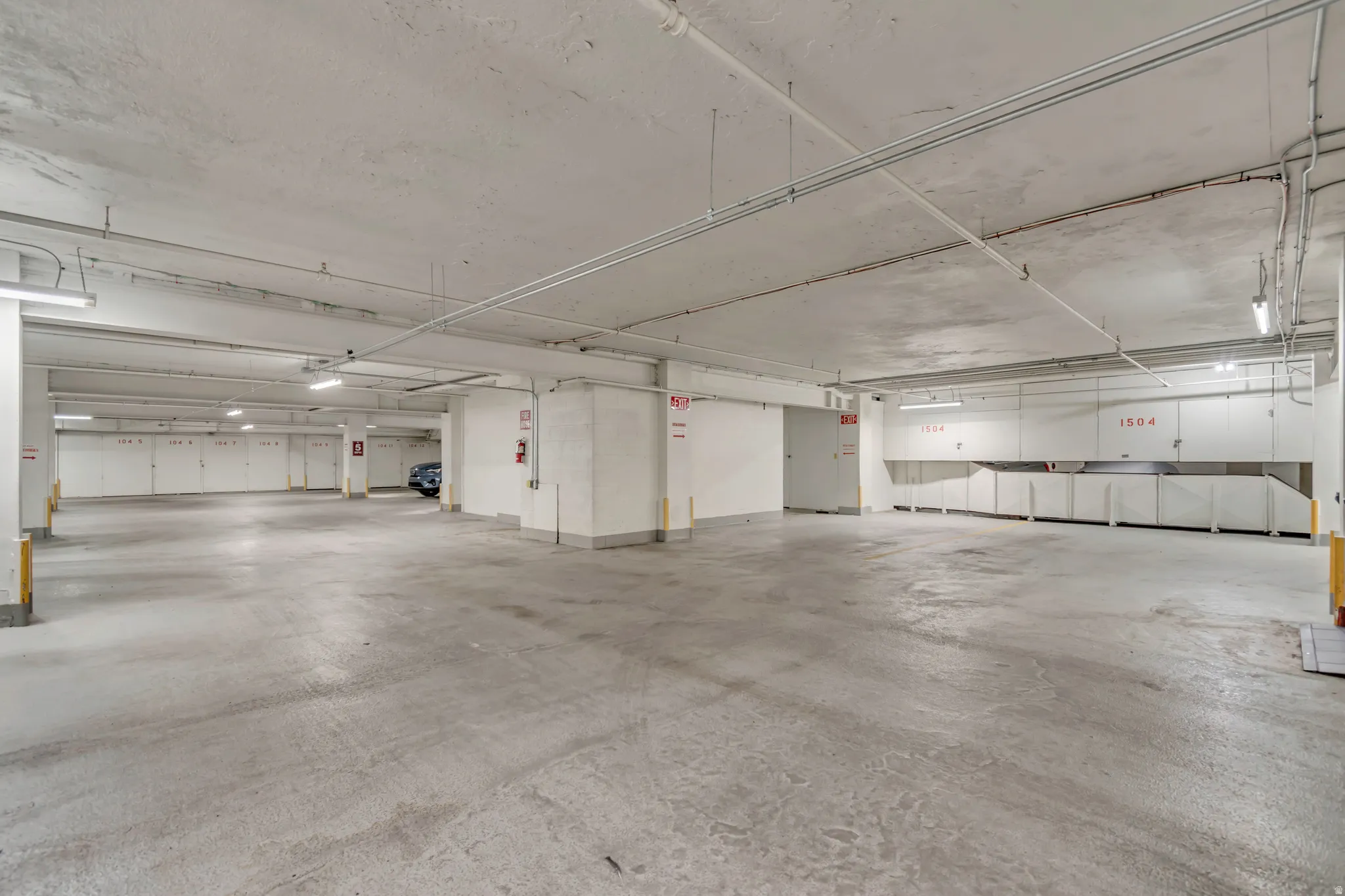 Subterranean parking garage with concrete flooring