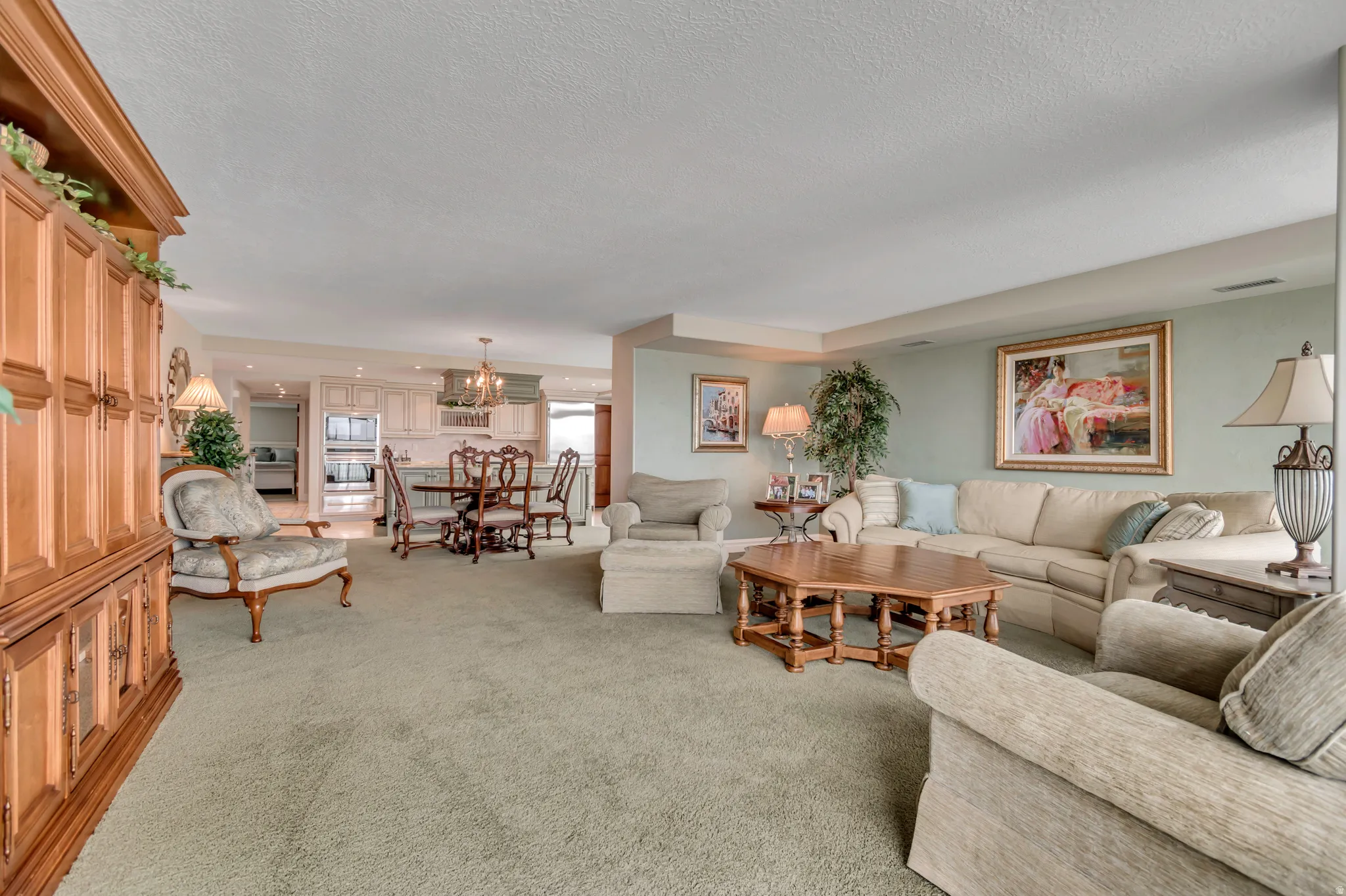 Expansive living area featuring carpet flooring, and light-toned wall paint