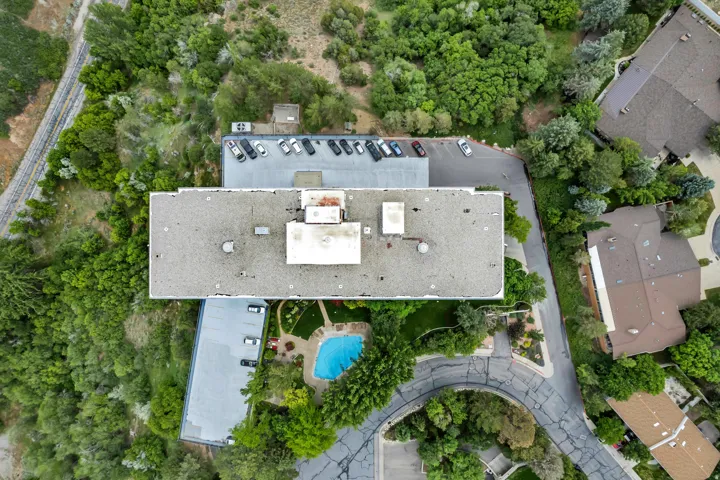 Aerial perspective showcasing the parking and common area pool and gardens