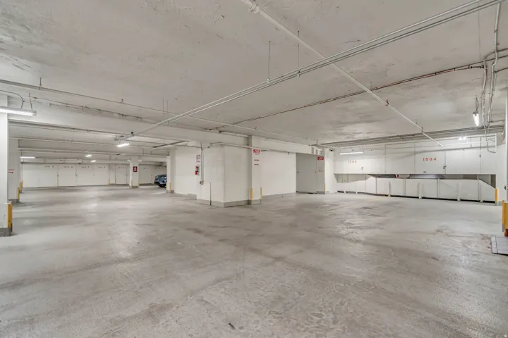 Subterranean parking garage with concrete flooring