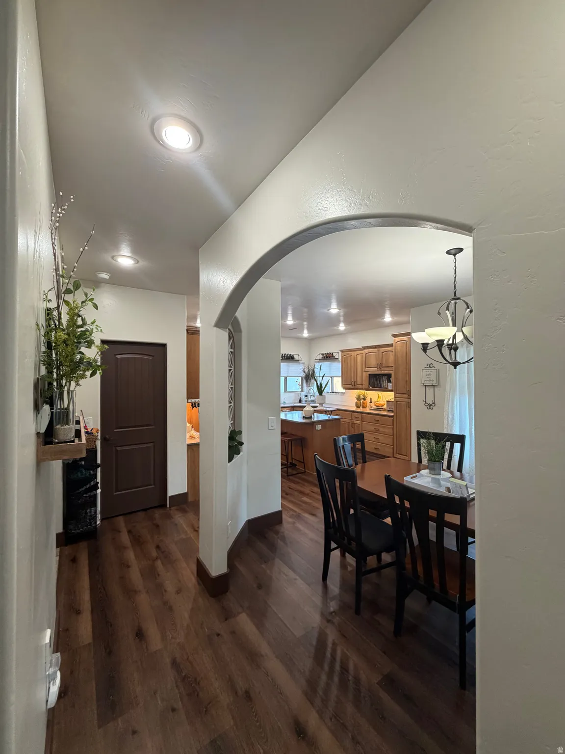 Archway entry leading to an open-concept dining area and kitchen