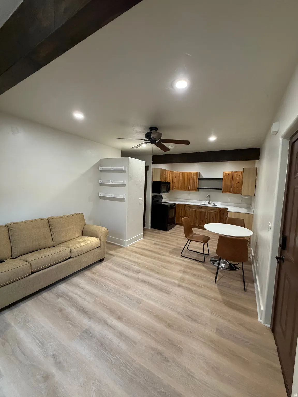 Open-concept living space with light wood-finish flooring