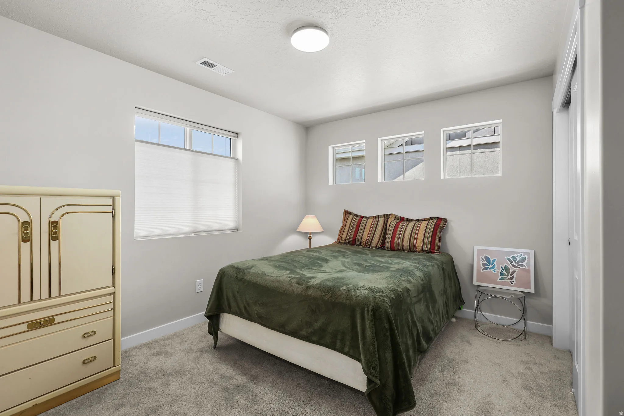 Carpeted room featuring light gray walls and white trim