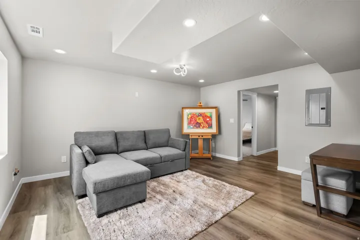 Open concept living area featuring wood-finish flooring, recessed lighting, and a neutral wall palette