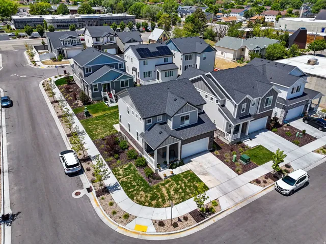 Modern residential development featuring multi-story homes with dark shingle roofs
