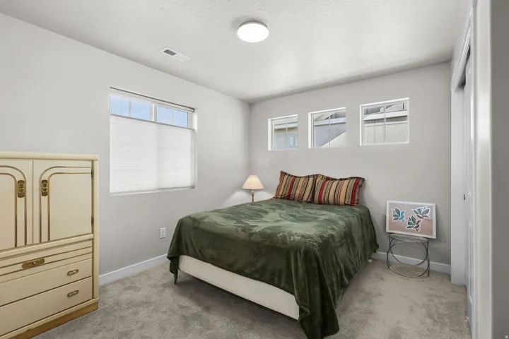 Carpeted room featuring light gray walls and white trim