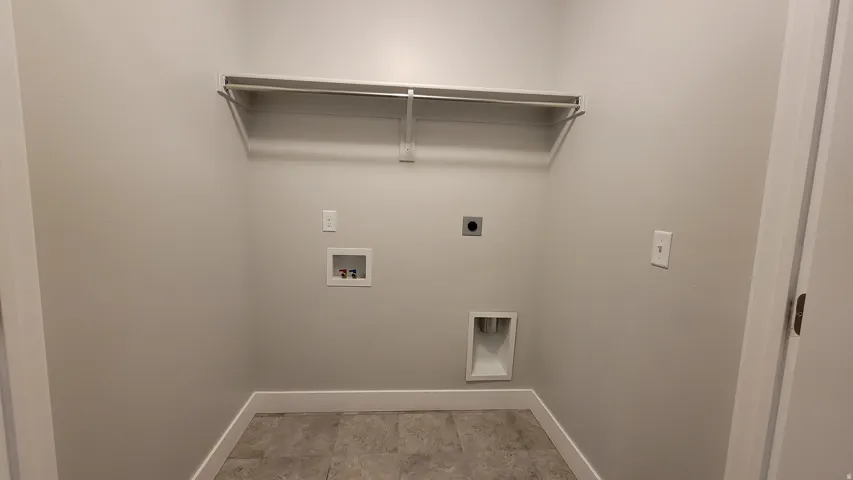 Dedicated utility space featuring a built-in wire shelf and hanging rod