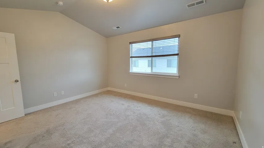 Carpeted interior room featuring light gray wall paint and white trim