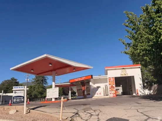 Commercial property featuring a large canopy structure, and unique drive through