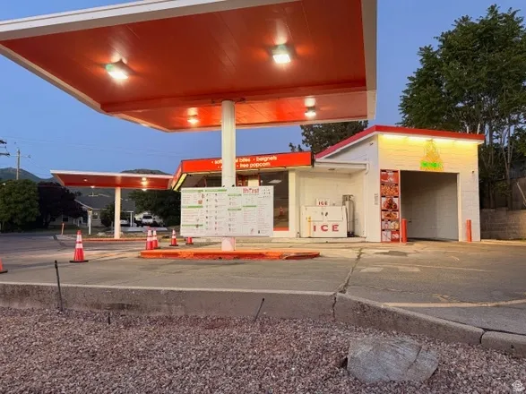 Commercial property featuring a large orange canopy with integrated lighting