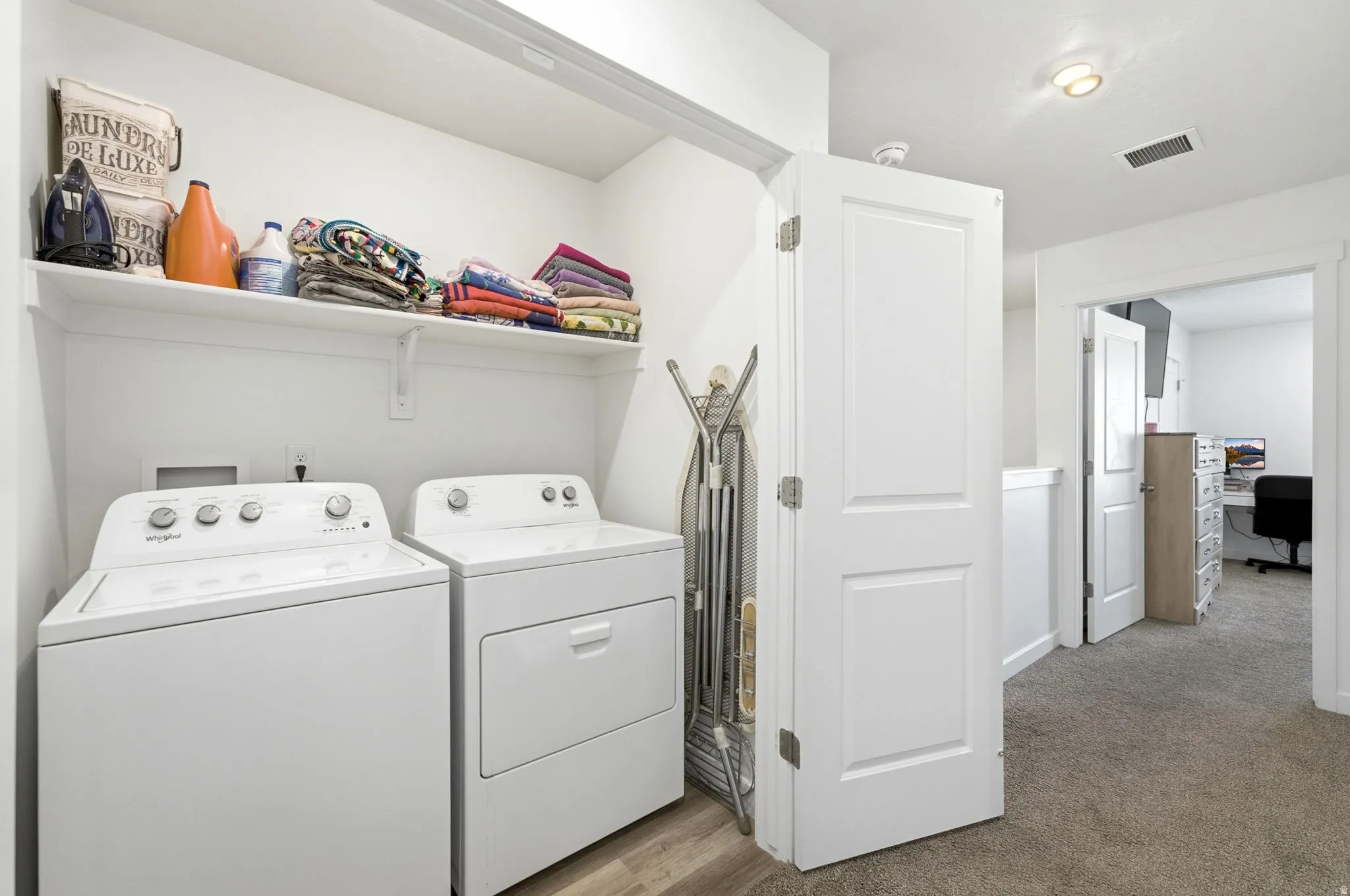 Dedicated laundry area featuring a white top-load washer and front-load dryer