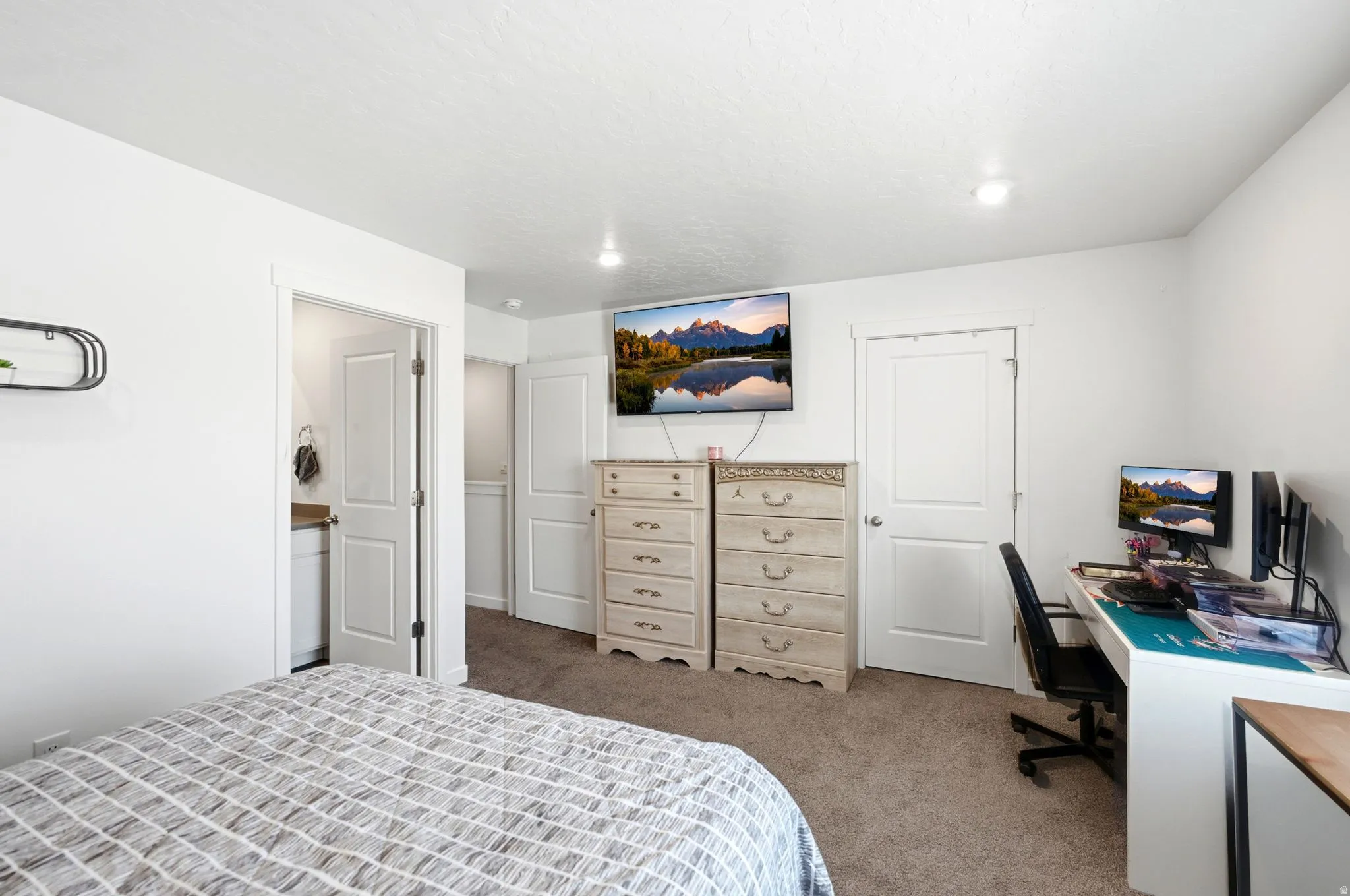 Primary room with a wall-mounted television and built-in lighting
