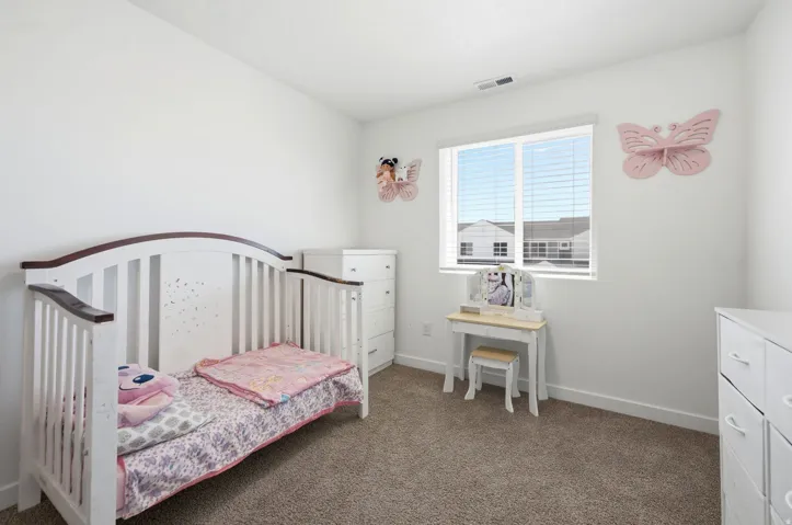 Neutral white walls with brown-toned carpeting