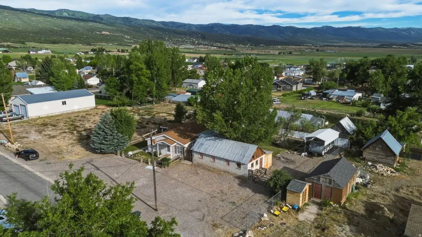 Aerial perspective showcasing the property with multiple structures and surrounding landscape