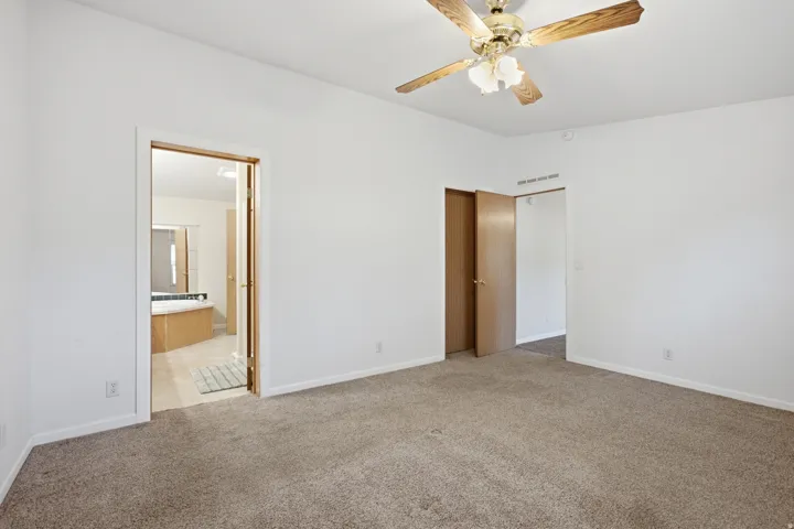 Bedroom #3, featuring a ceiling fan with light fixture and closet