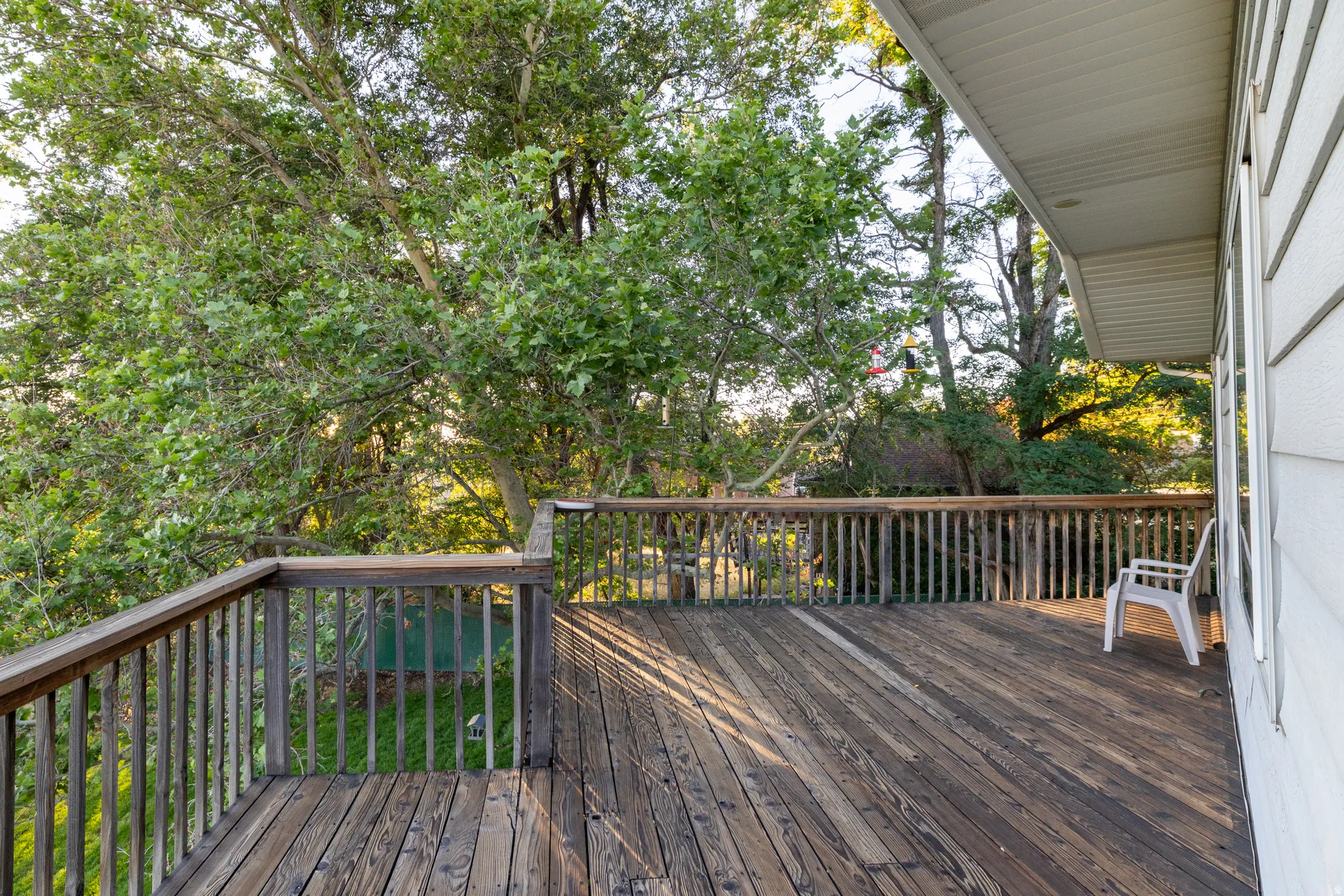 Expansive wood deck with a full wood railing, providing a spacious outdoor area