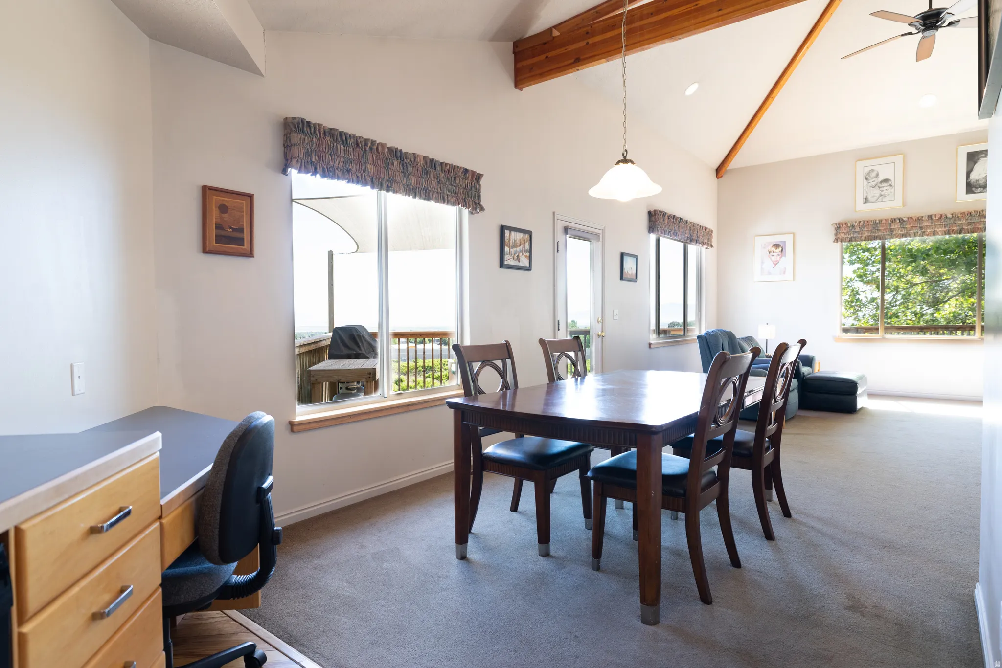 Vaulted ceiling featuring exposed wood beams