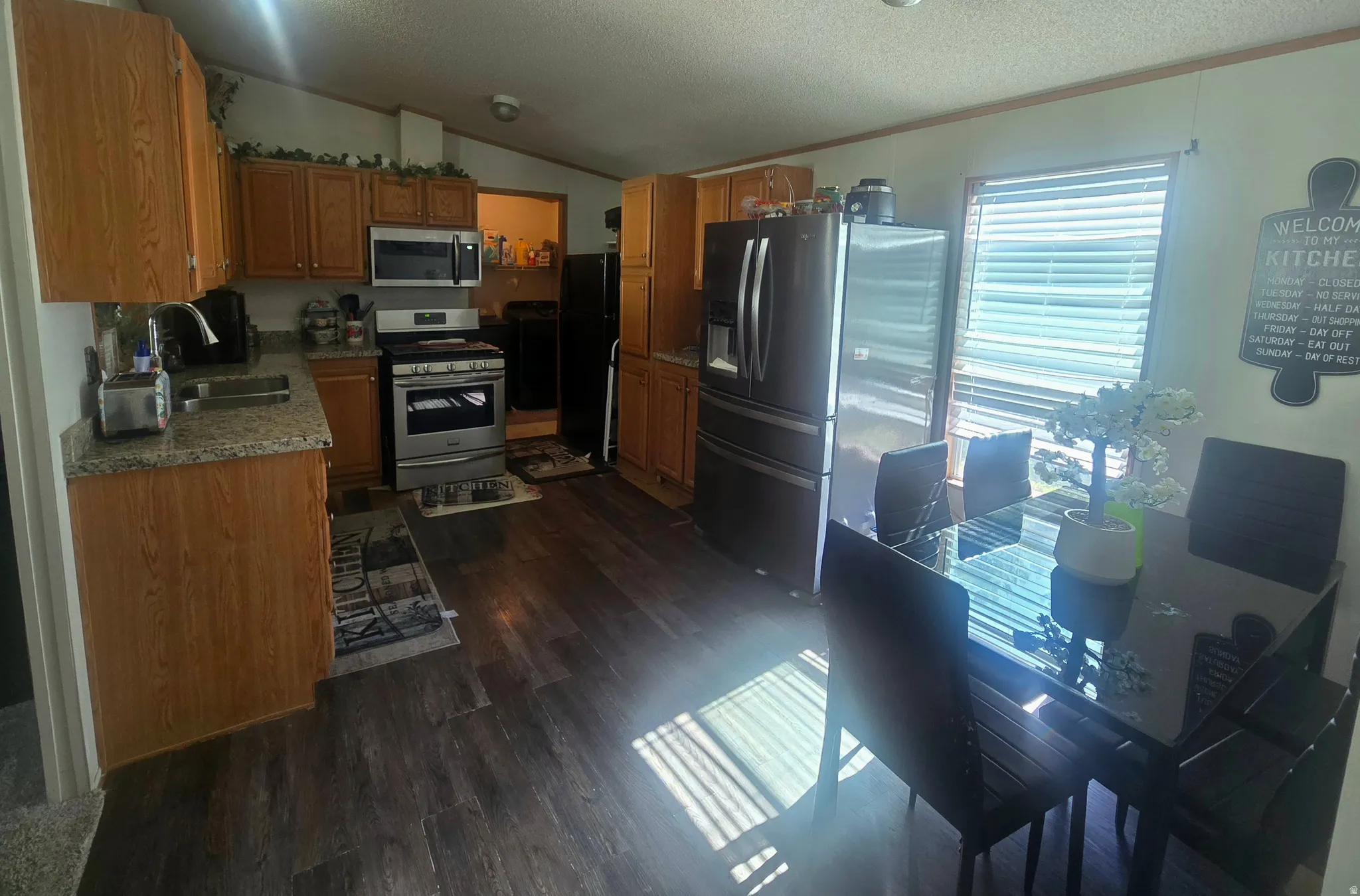 Open concept kitchen and dining area with wood-finish flooring