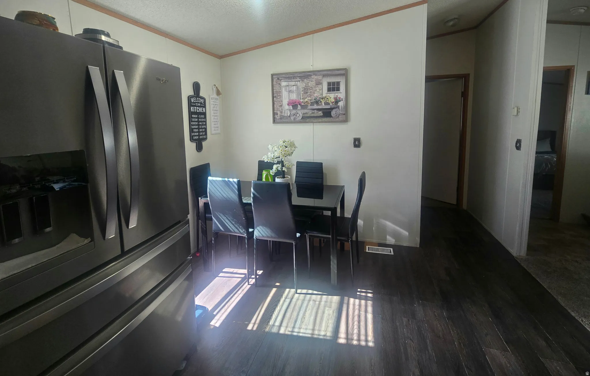 Dining area with wood-finish flooring, featuring a dedicated space for a dining table