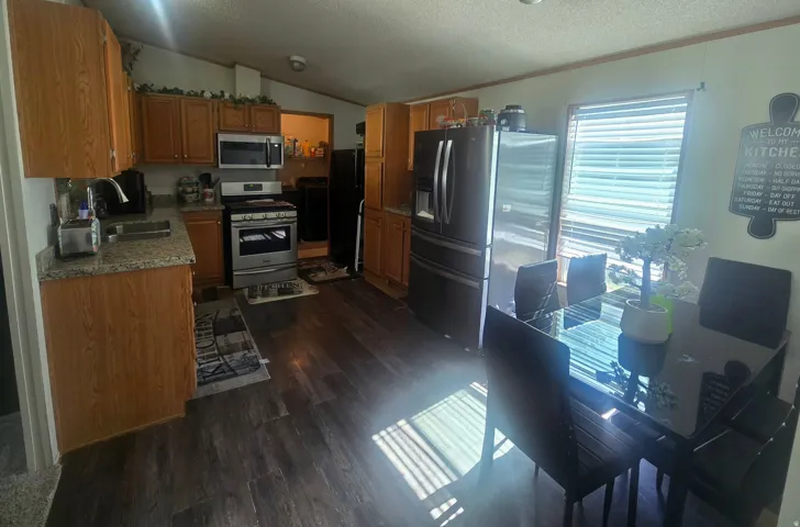Open concept kitchen and dining area with wood-finish flooring