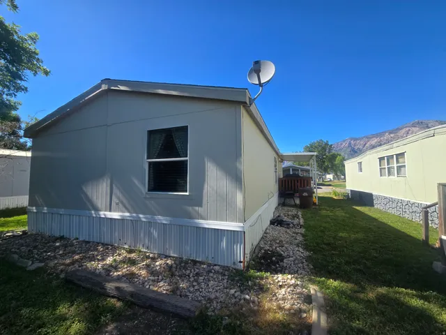 Exterior siding with white trim and a gravel border