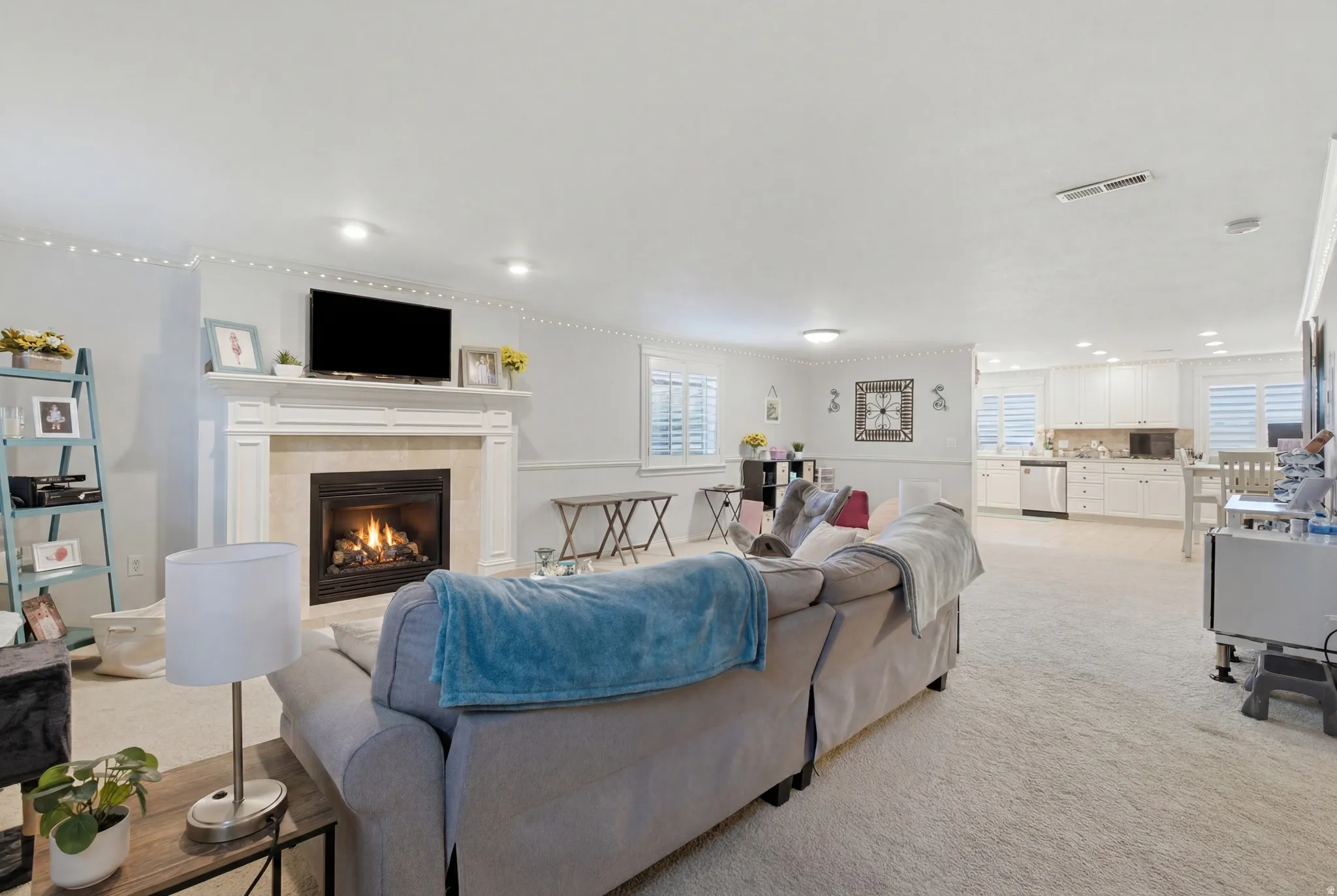 Living area featuring a fireplace with a stone surround and ornate mantel
