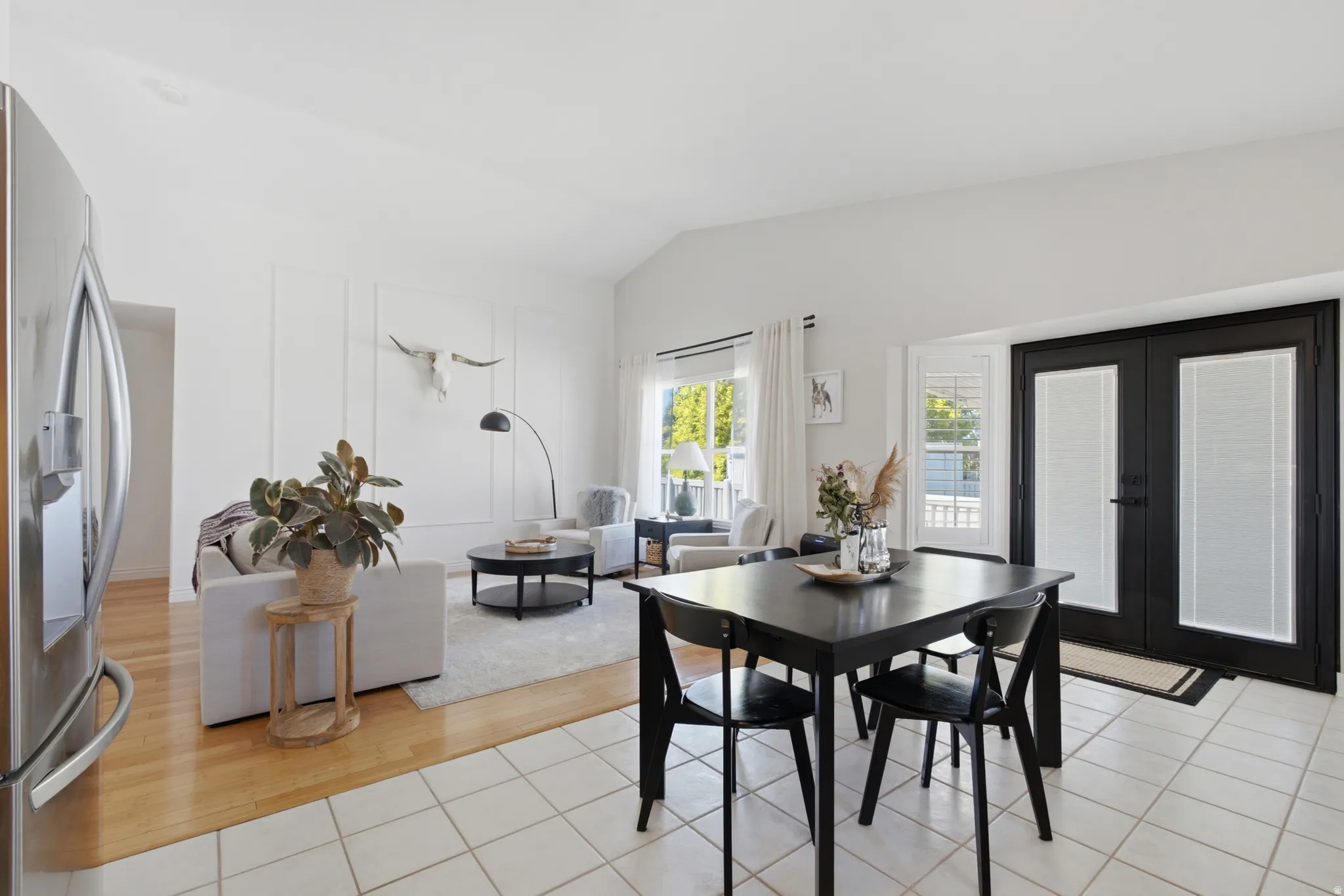 Spacious interior featuring a vaulted ceiling and a board and batten accent wall