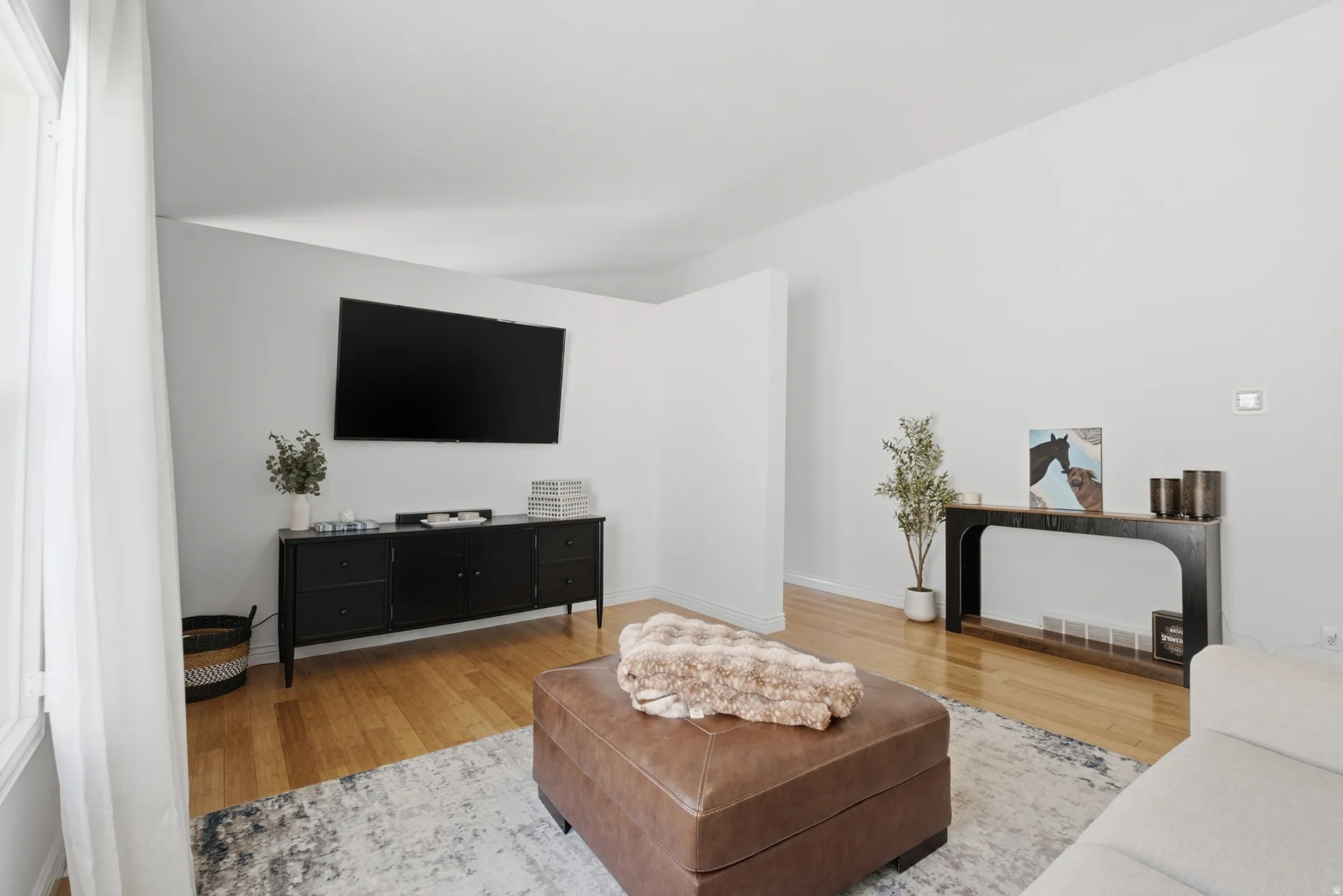 Light-toned wood-finish flooring throughout