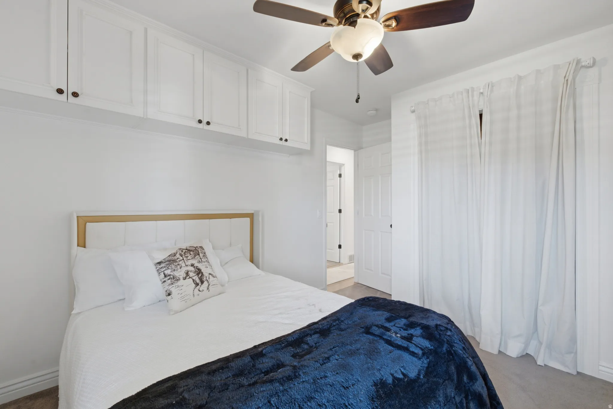 Recessed white cabinetry with dark hardware