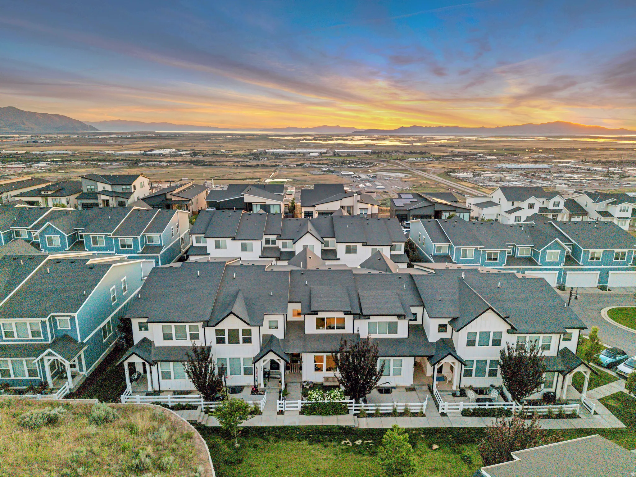 Contemporary townhome community featuring diverse architectural styles and dark-shingle roofing