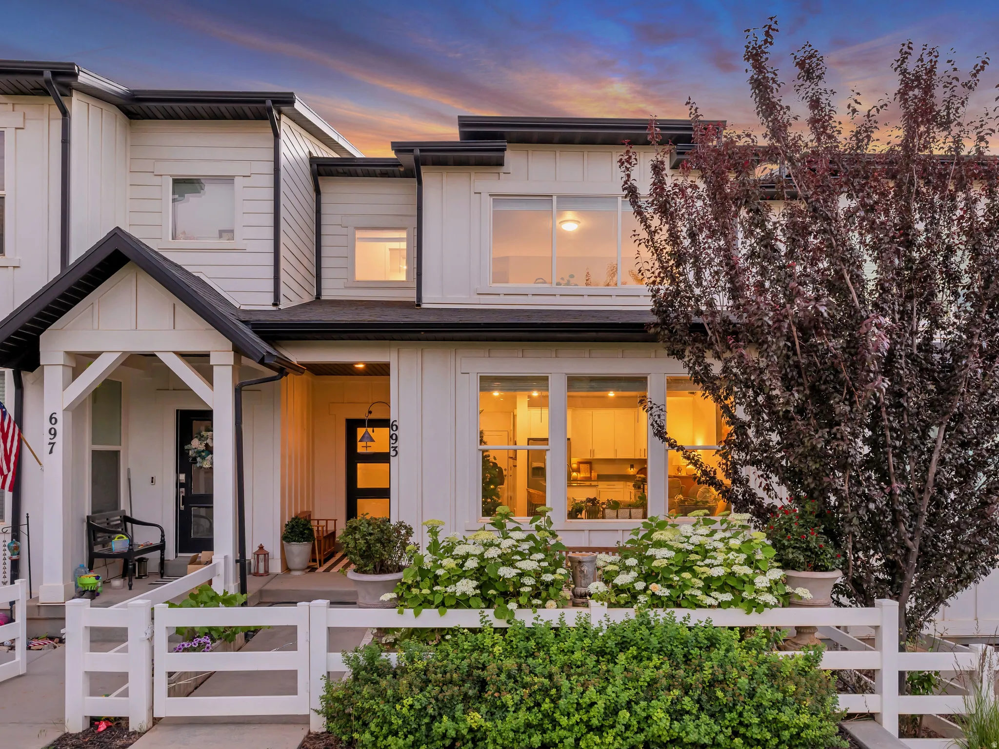 Modern exterior with white siding and black trim accents