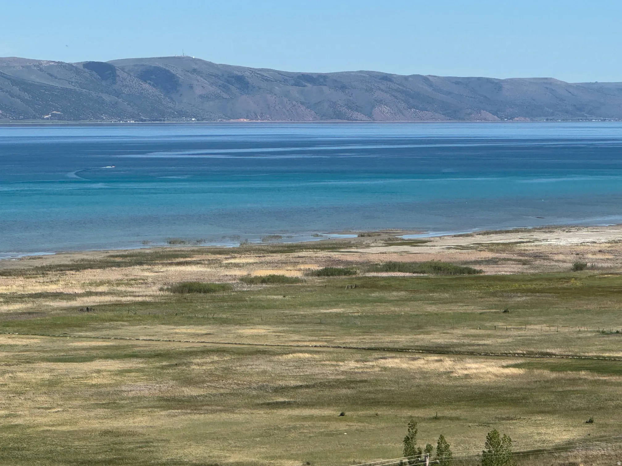 Expansive water frontage with mountain backdrop