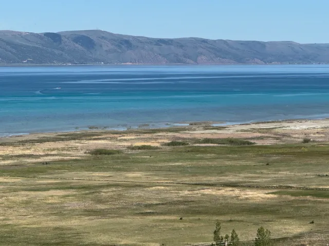 Expansive water frontage with mountain backdrop