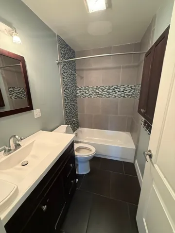 Dark wood-finish vanity with an integrated sink and chrome faucet
