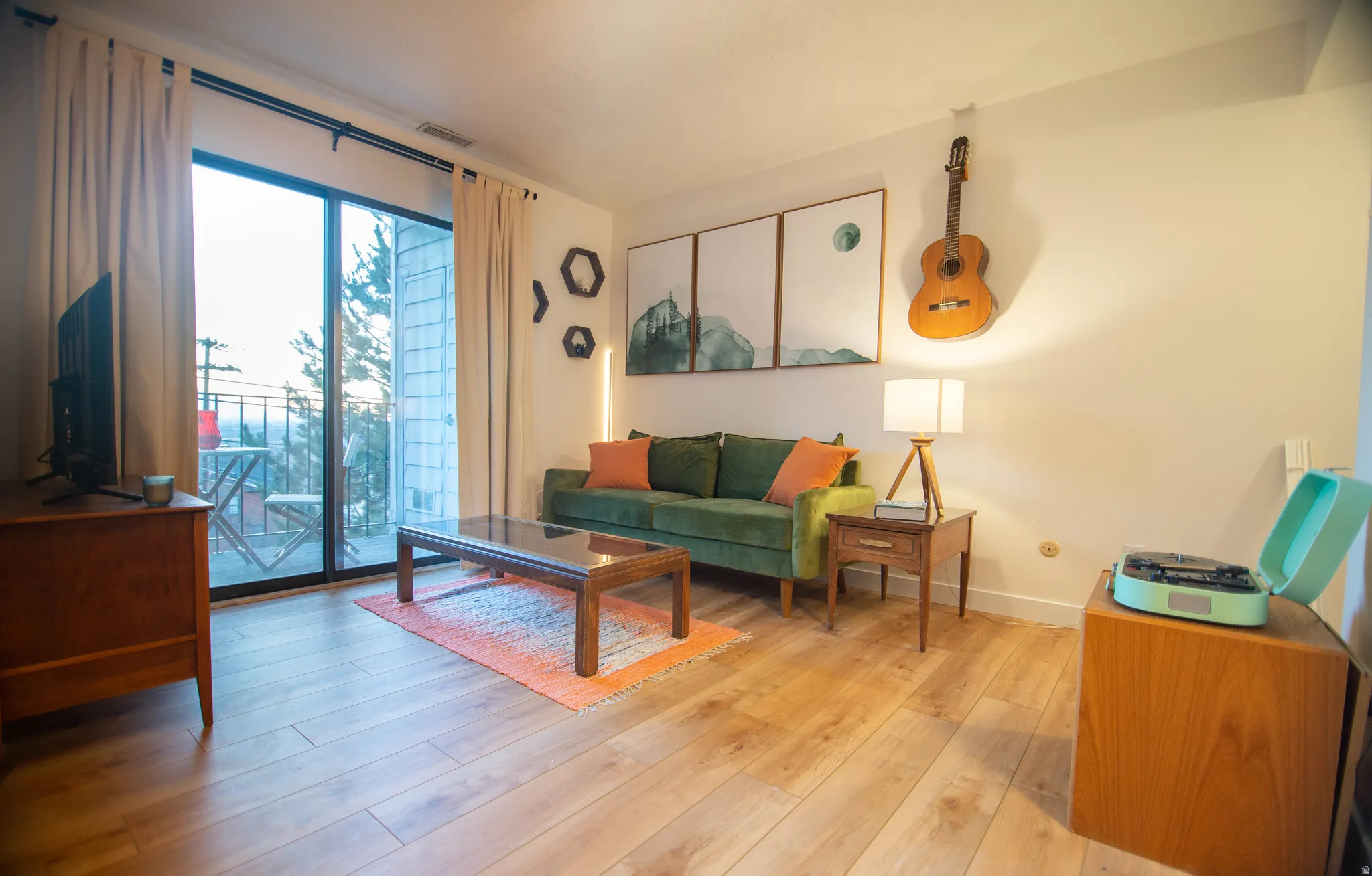 Living space featuring wood-finish flooring and direct balcony access through sliding glass doors