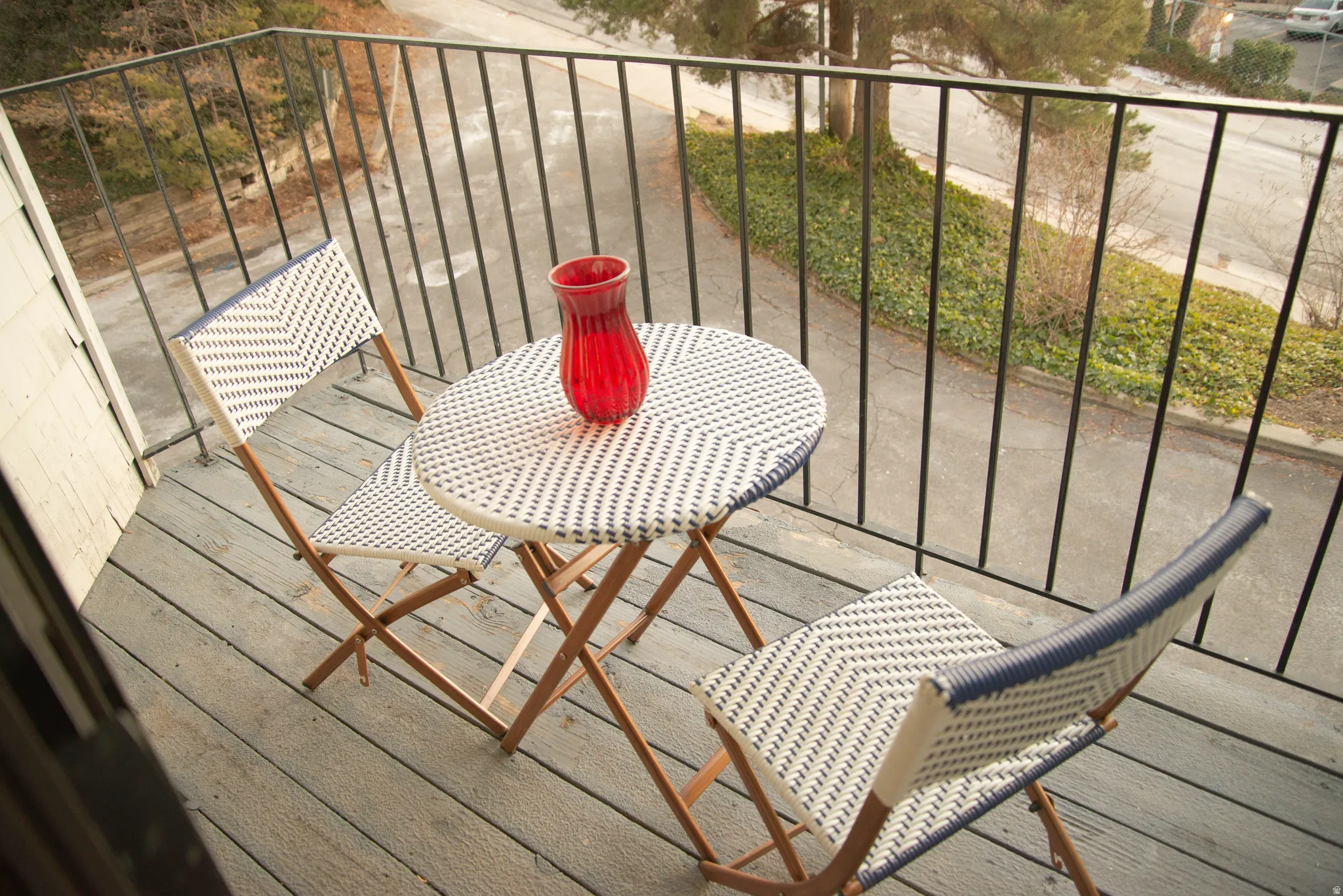 Balcony with wood-finish flooring and black metal railings